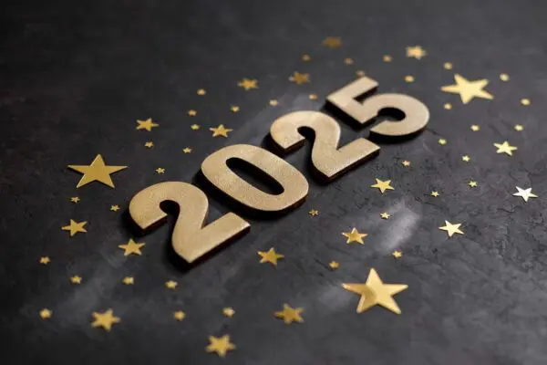 Golden numbers 2025 with gold stars on dark background. New Year greeting card