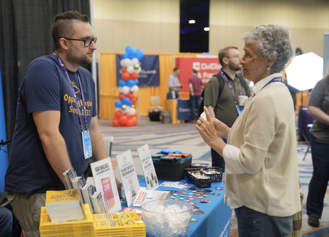 LCI FreedomFest Jacob Talks to Attendee