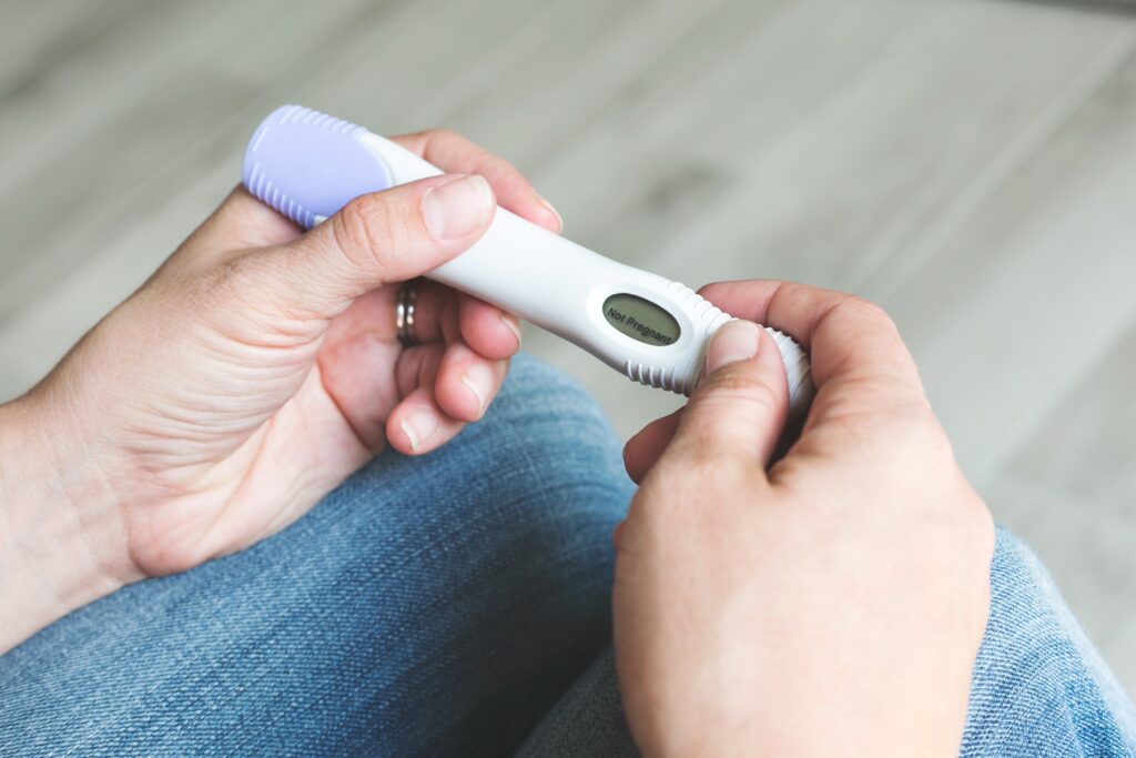 Abortion and Bastiat's Seen and Unseen 2 hands hold pregnancy test