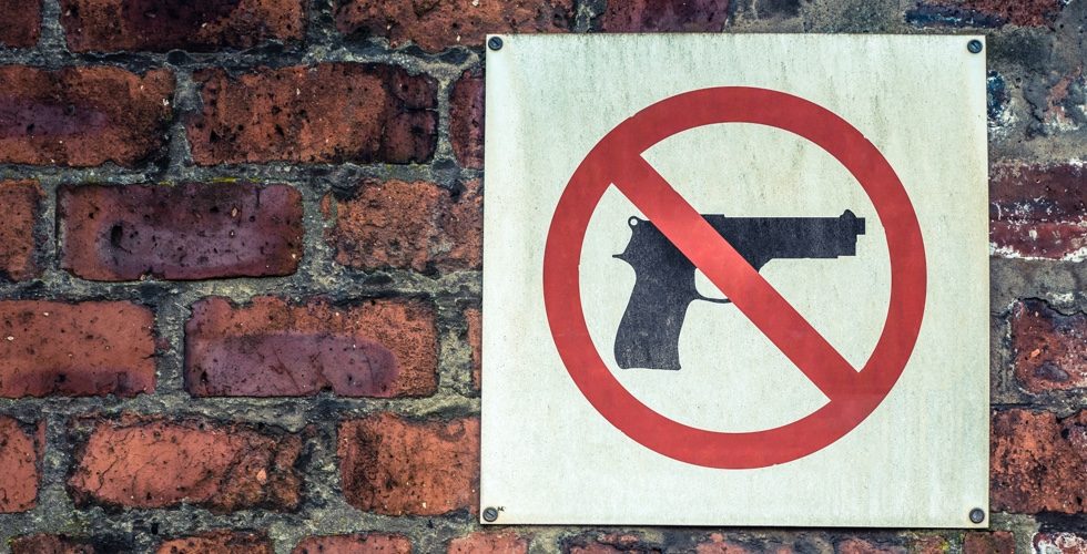A Grungy No Guns Sign On A Business Or School Or University In The USA